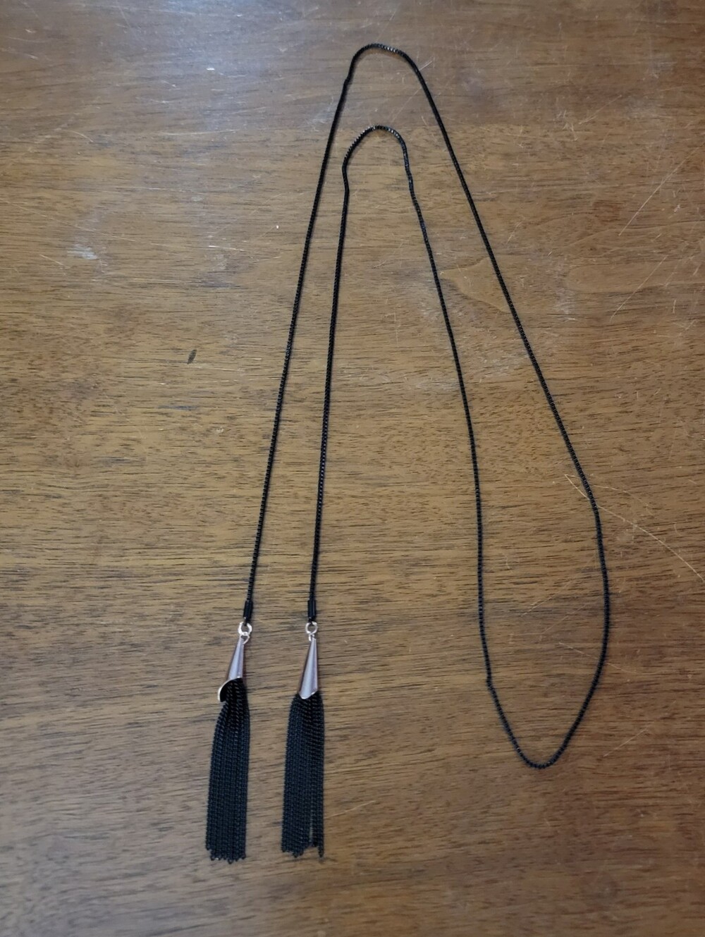 Black metal chain with a tassel at each end